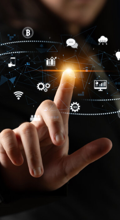 A man in a suit gesturing toward the details on a large, stylized identification card.