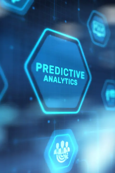 A hand pointing toward a glowing blue hexagonal digital interface button labeled 'PREDICTIVE ANALYTICS,' surrounded by other data-themed icons in a high-tech, futuristic environment.