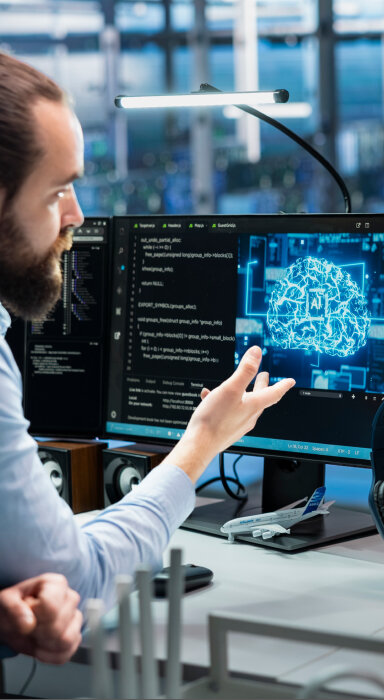 Graphic of a person connecting human creativity—represented by a lightbulb—to an AI processor.