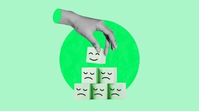 Hand stacking cubes with happy and sad faces, representing customer feedback analysis by an online marketing service provider