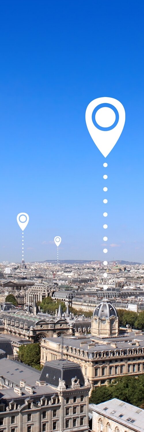 Mobile phone with a magnifying glass focusing on a location pin, emphasizing the importance to optimize for local search and Google Business optimization