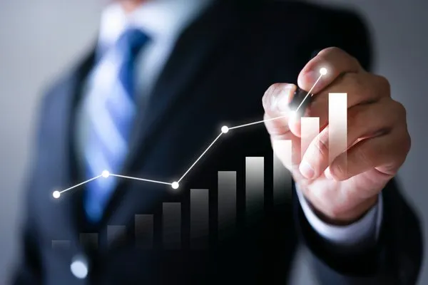 Businessman pointing to an upward growth chart